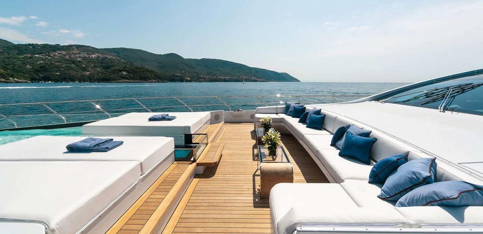 a deck with a large body of water and a large boat in the background aboard EL LEON Yacht for Sale
