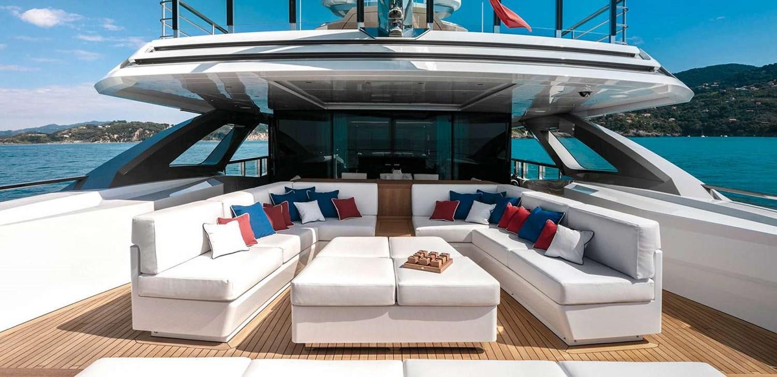 a large white boat with a couch and pillows on a large body of water aboard EL LEON Yacht for Sale