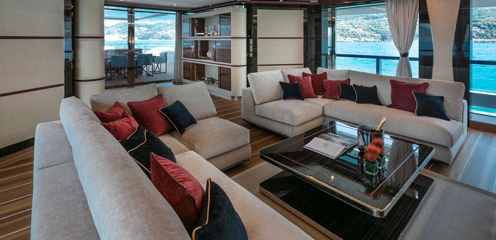 a living room with a couch and a coffee table aboard EL LEON Yacht for Sale