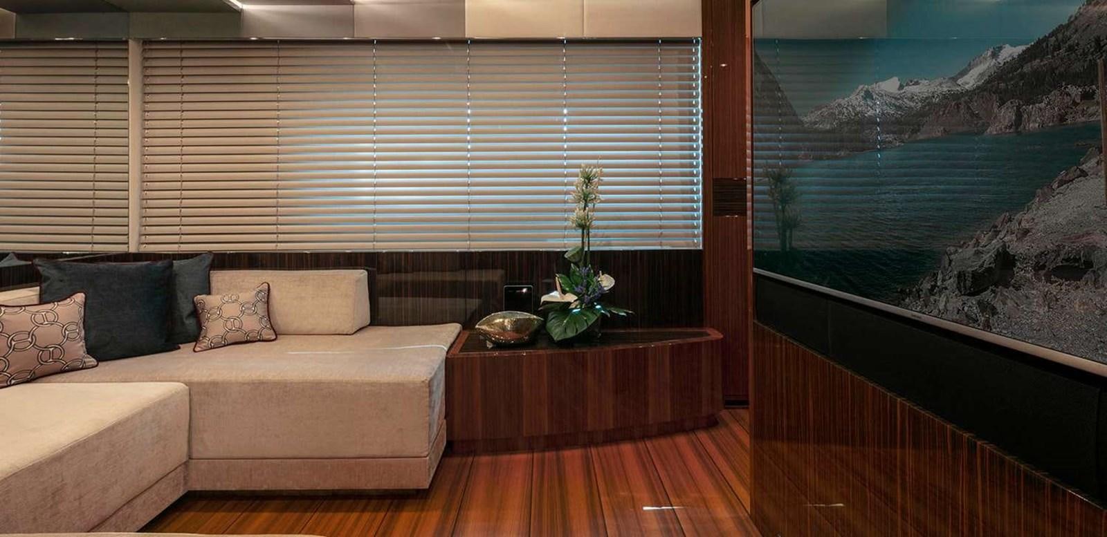 a room with a couch and a table and a plant on the table aboard EL LEON Yacht for Sale