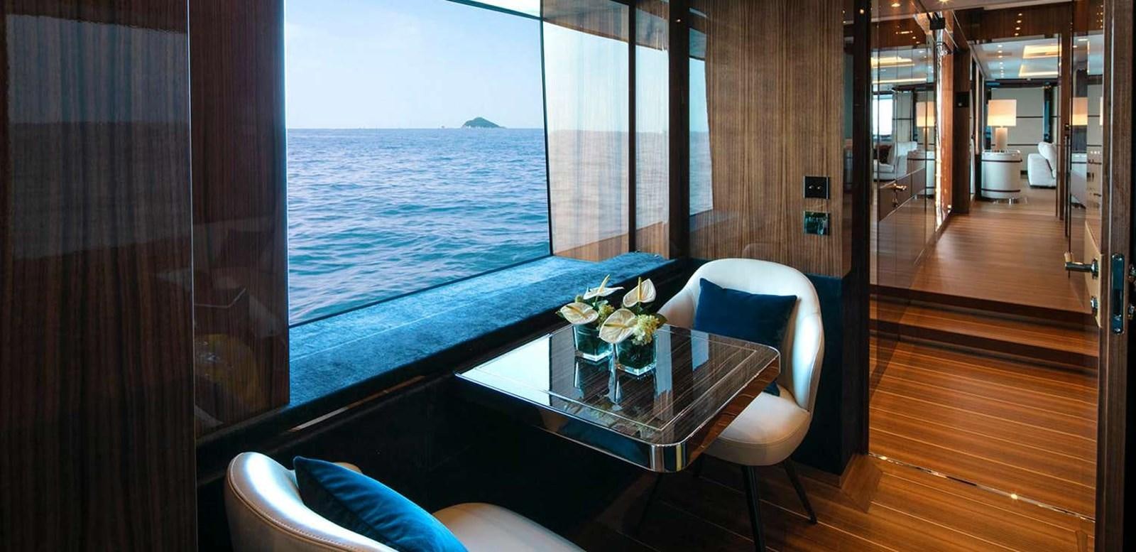 a room with a table and chairs aboard EL LEON Yacht for Sale