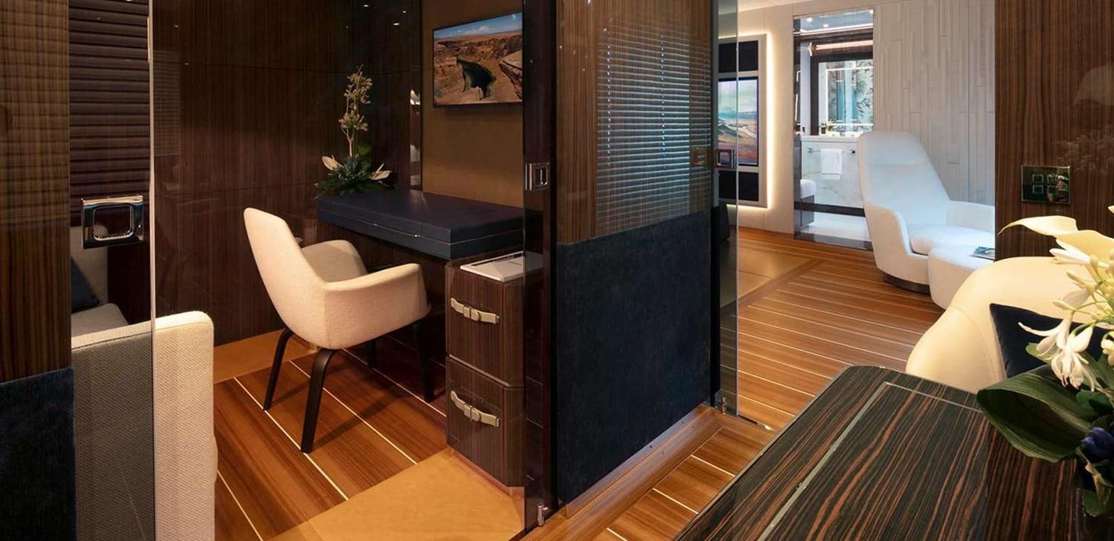 a room with a desk and chairs aboard EL LEON Yacht for Sale