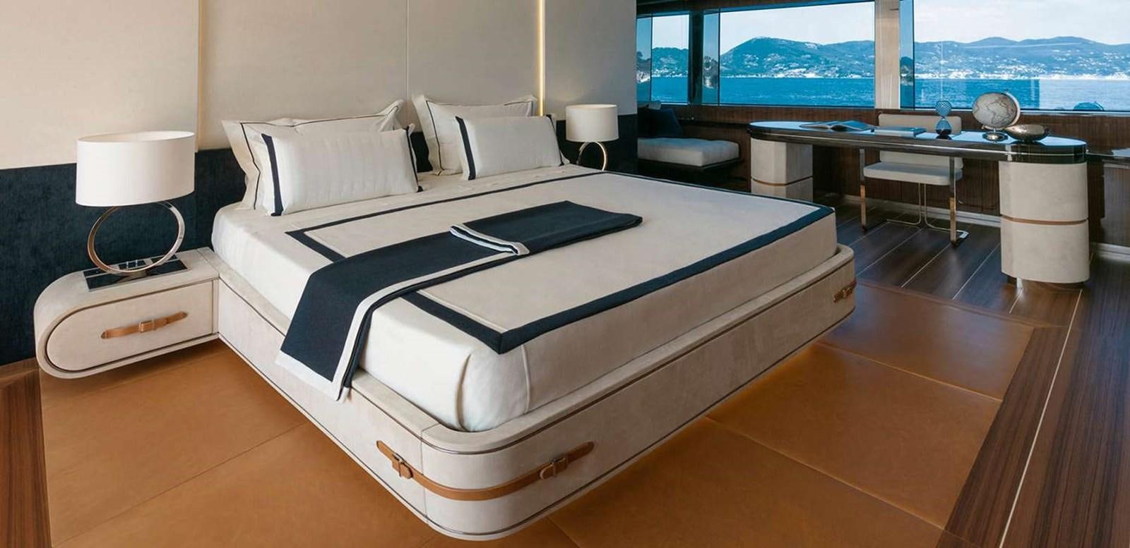 a bed with a white sheet on it aboard EL LEON Yacht for Sale