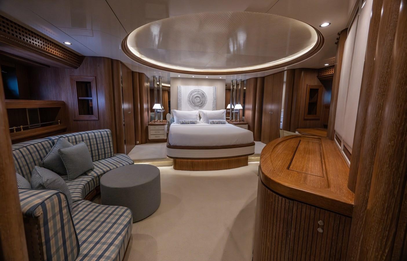 a large room with a chandelier and a couch aboard TAIPAN OF WALES Yacht for Sale