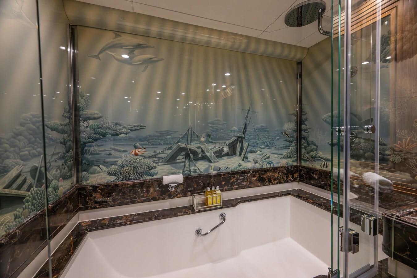 a bathroom with a large glass window aboard TAIPAN OF WALES Yacht for Sale