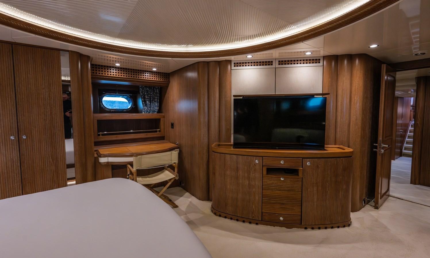 a hotel room with a tv and bed aboard TAIPAN OF WALES Yacht for Sale