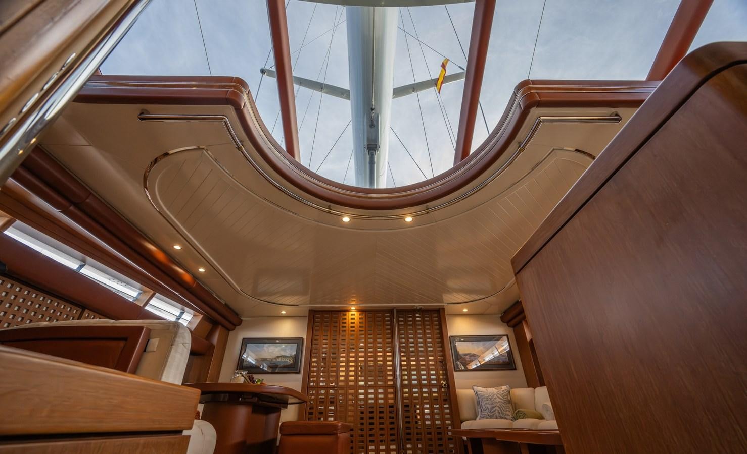 a room with wooden floors and a large chandelier aboard TAIPAN OF WALES Yacht for Sale