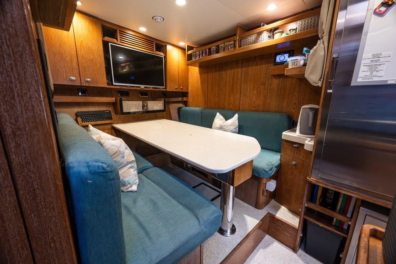 a room with a bed and a desk aboard TAIPAN OF WALES Yacht for Sale