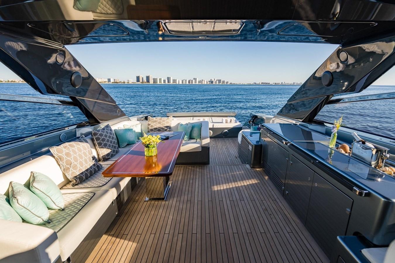 a deck with a table and chairs on it aboard 2021 RIVA 76' BAHAMAS Yacht for Sale