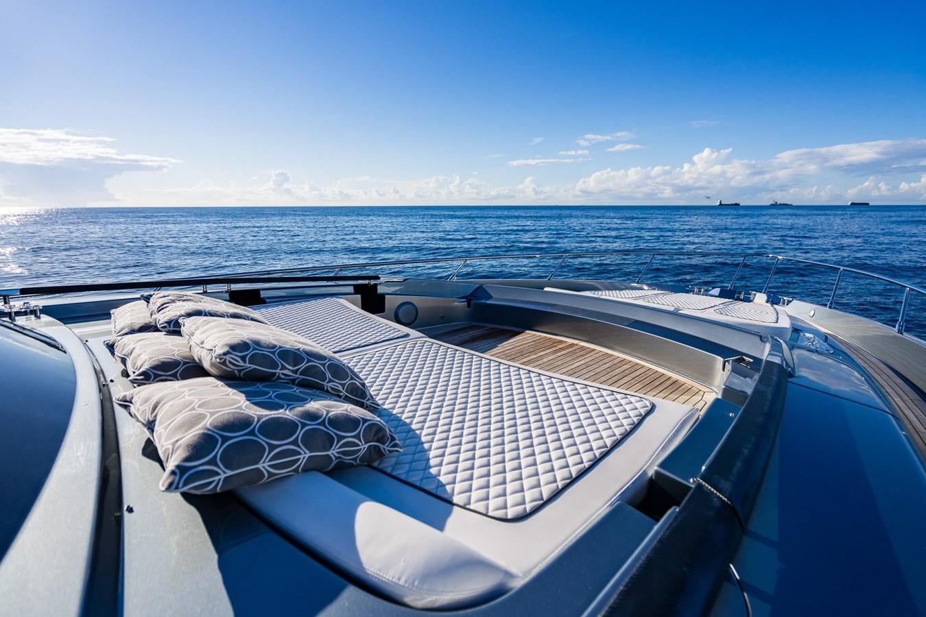 a person lying on a boat aboard 2021 RIVA 76' BAHAMAS Yacht for Sale