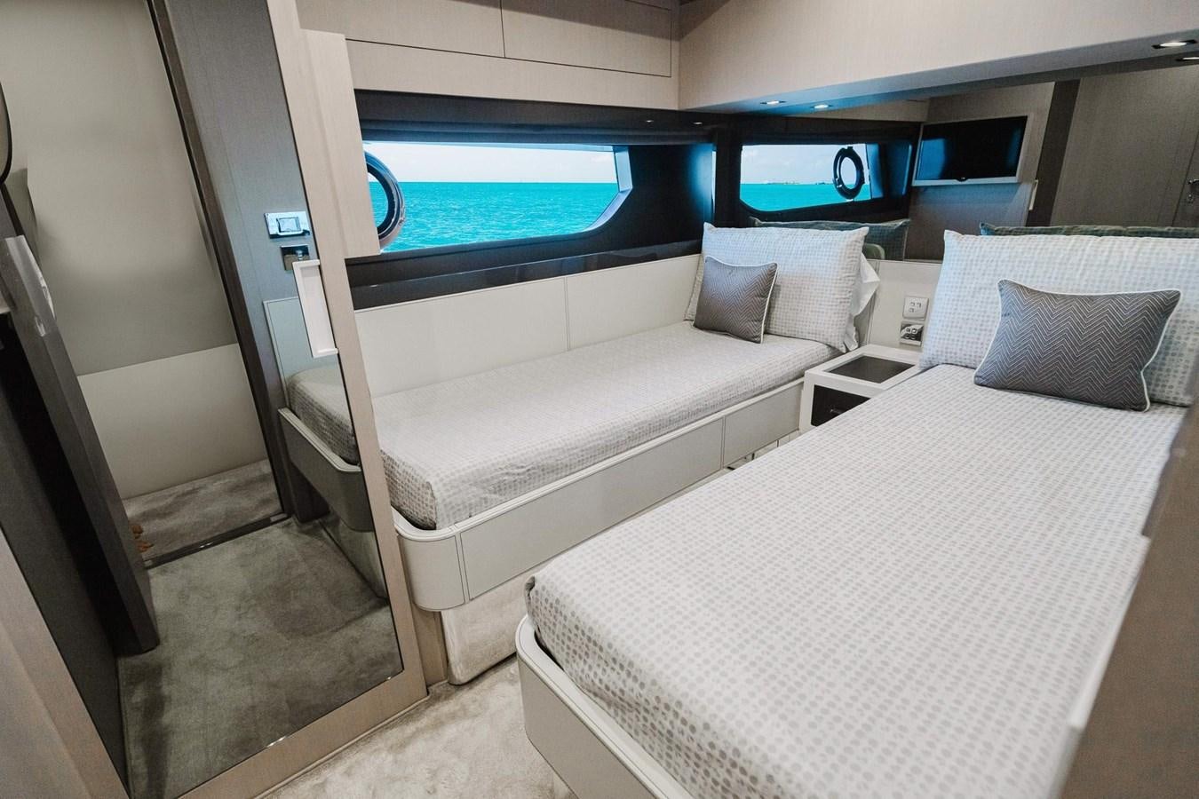 a room with beds and a window aboard 2021 RIVA 76' BAHAMAS Yacht for Sale