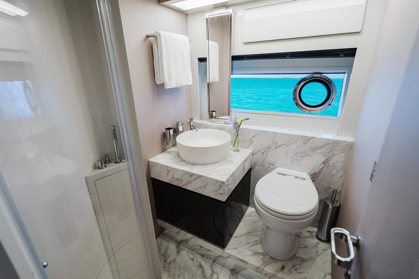 a bathroom with a toilet and sink aboard 2021 RIVA 76' BAHAMAS Yacht for Sale