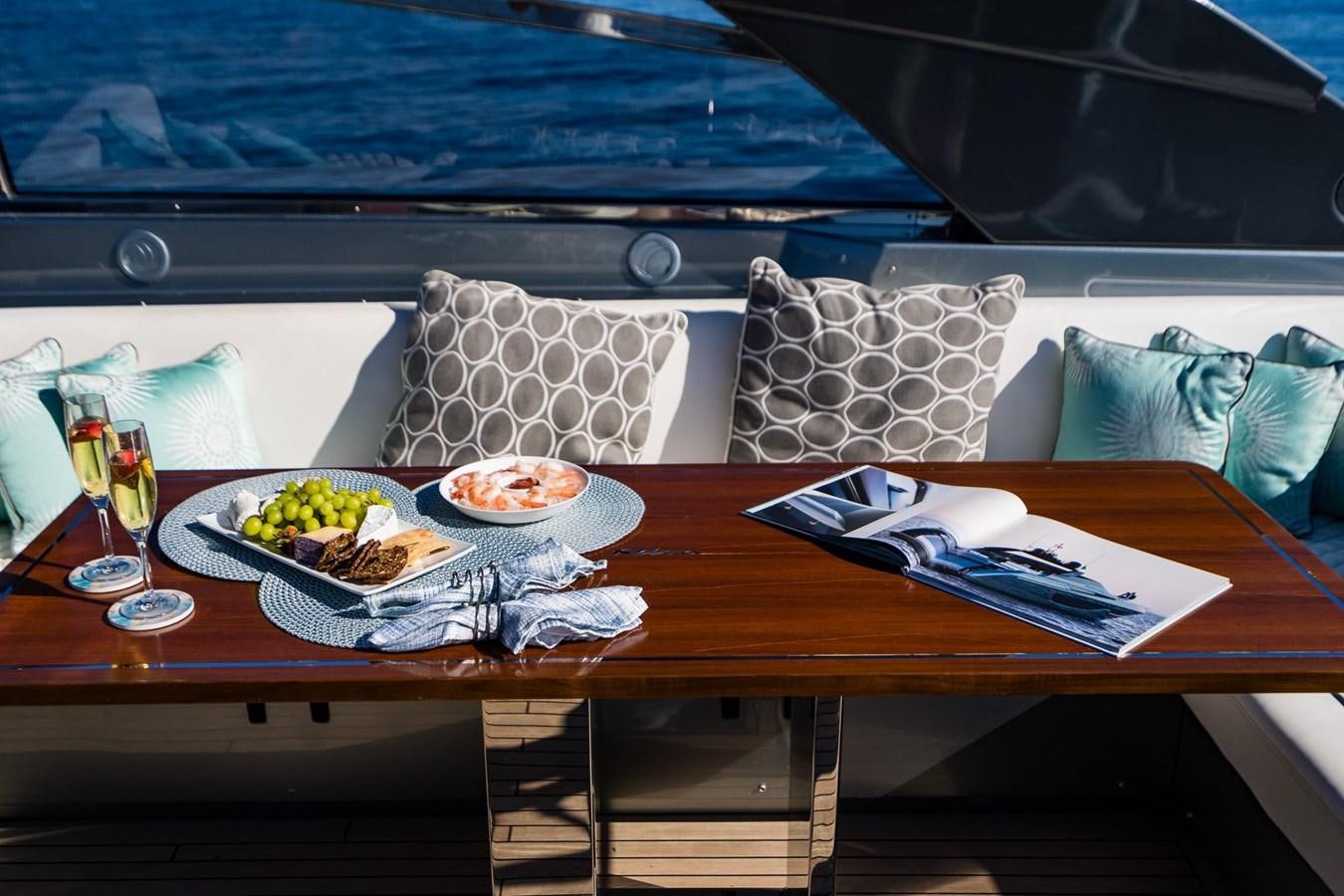 a table with food and drinks on it aboard 2021 RIVA 76' BAHAMAS Yacht for Sale