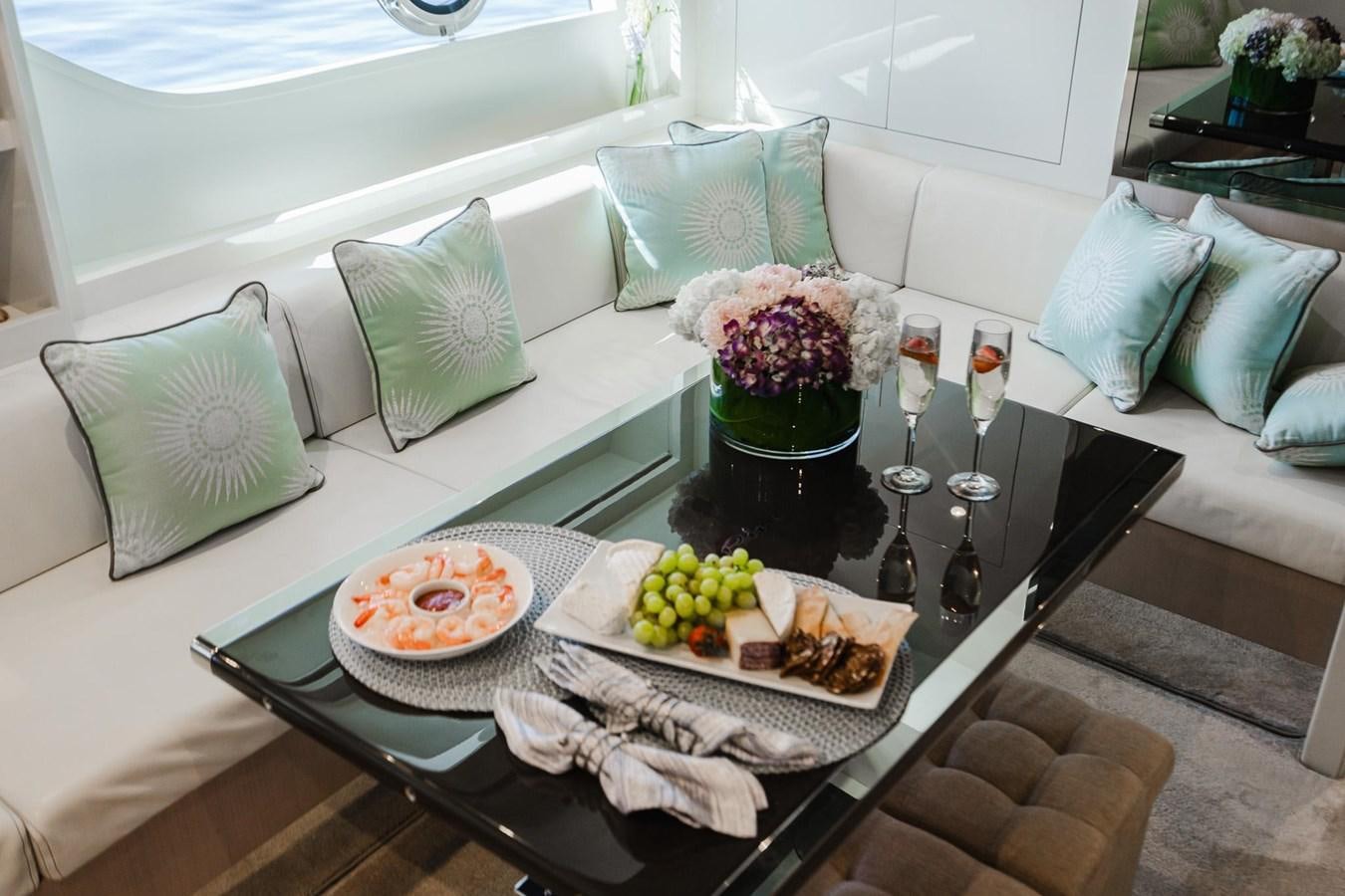 a table with food and drinks aboard 2021 RIVA 76' BAHAMAS Yacht for Sale