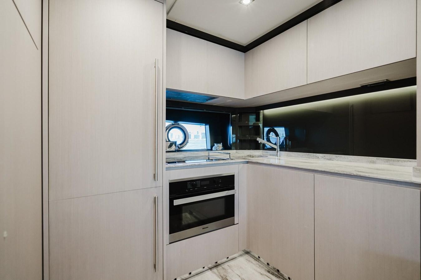 a kitchen with a microwave oven aboard 2021 RIVA 76' BAHAMAS Yacht for Sale