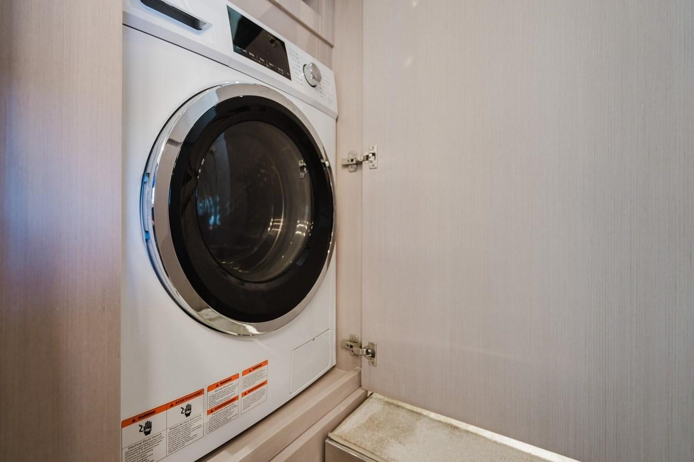 a white washing machine aboard 2021 RIVA 76' BAHAMAS Yacht for Sale