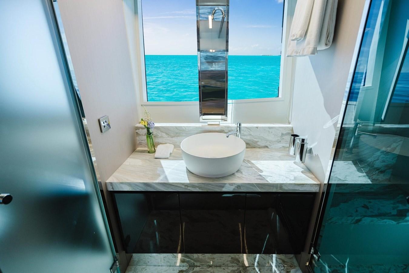 a bathroom with a sink and a window aboard 2021 RIVA 76' BAHAMAS Yacht for Sale