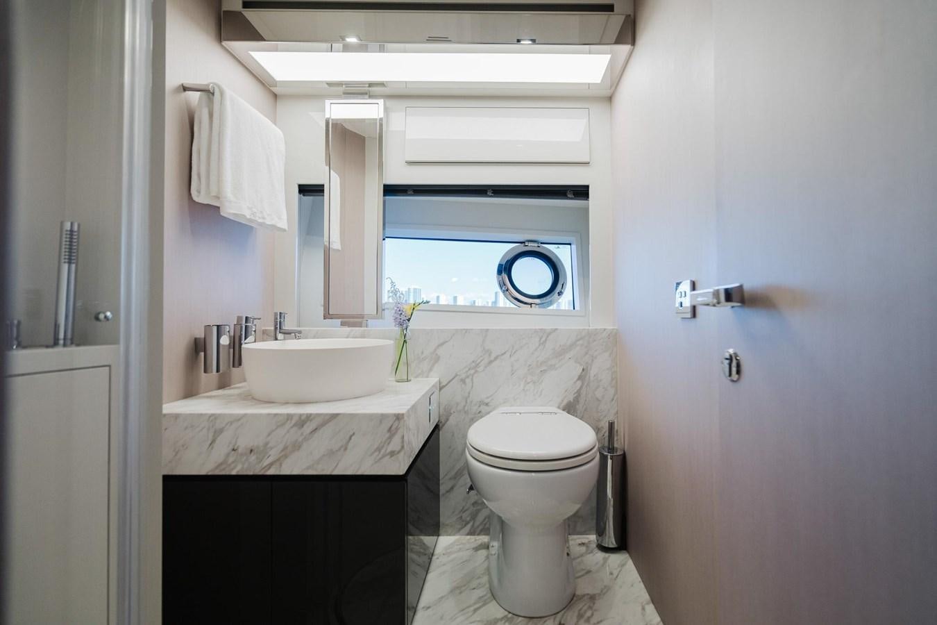 a bathroom with a toilet sink and a mirror aboard 2021 RIVA 76' BAHAMAS Yacht for Sale