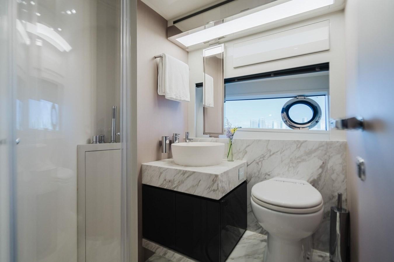 a bathroom with a sink toilet and a bathtub aboard 2021 RIVA 76' BAHAMAS Yacht for Sale