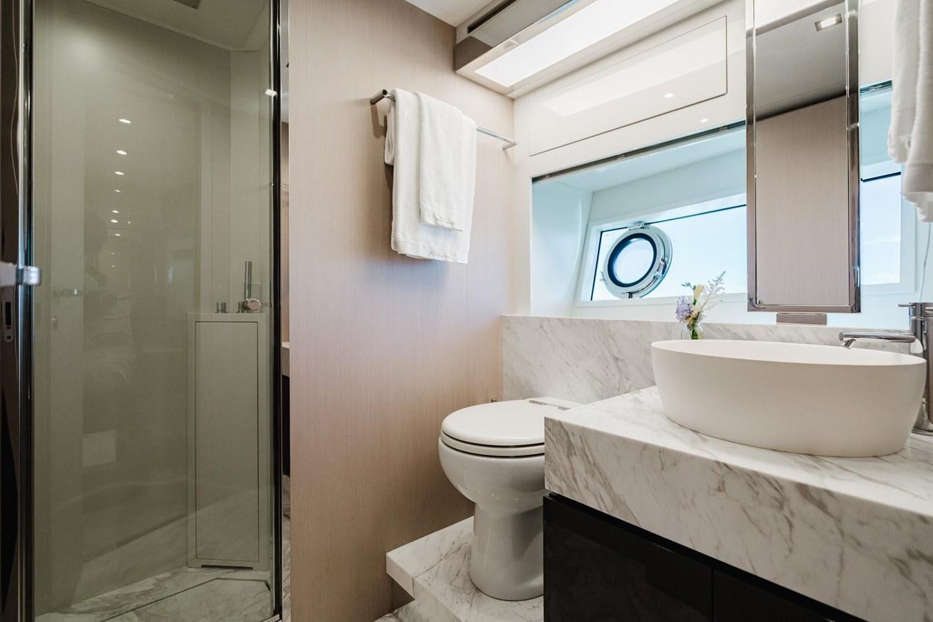 a bathroom with a tub sink and toilet aboard 2021 RIVA 76' BAHAMAS Yacht for Sale