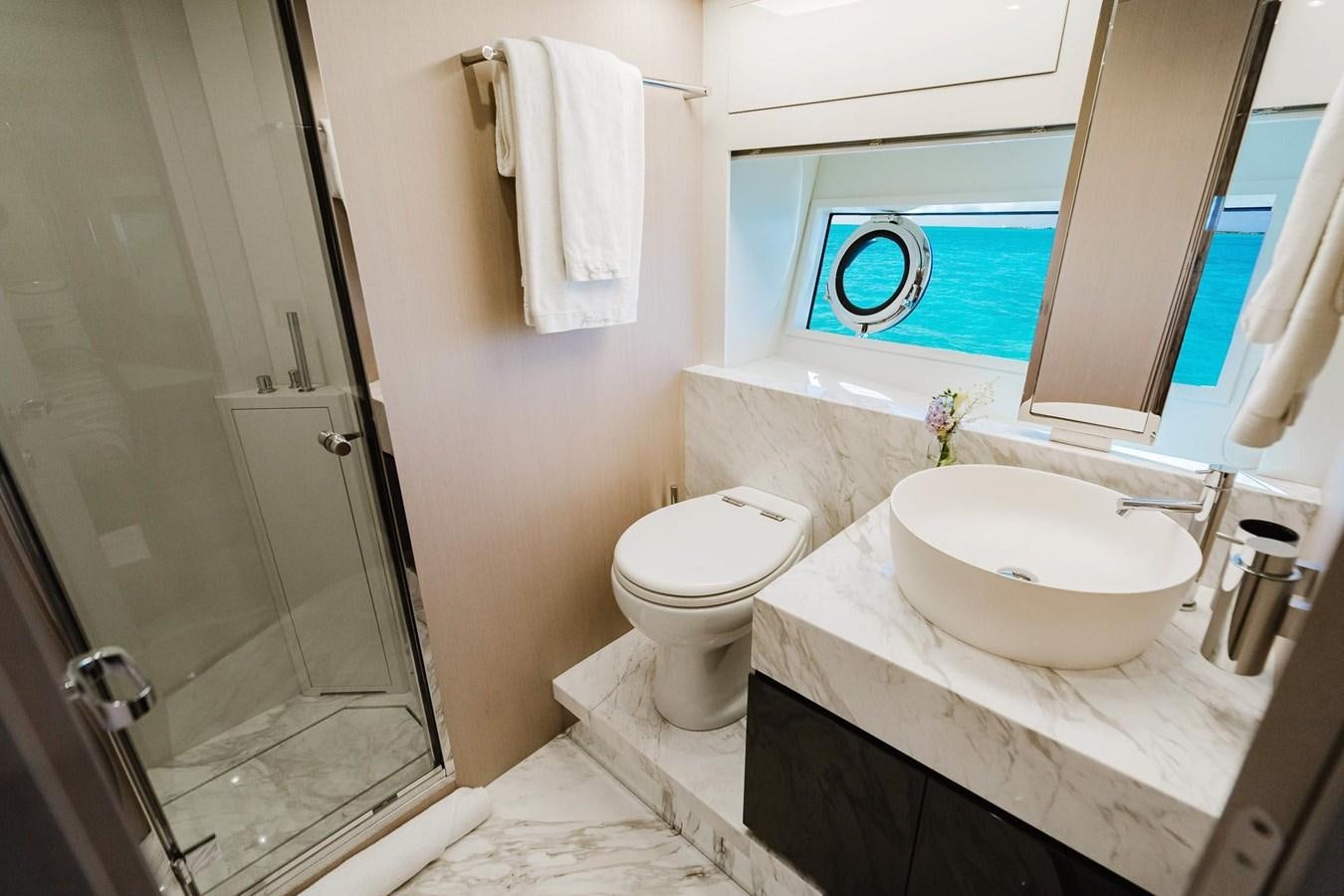 a bathroom with a sink toilet and a bathtub aboard 2021 RIVA 76' BAHAMAS Yacht for Sale