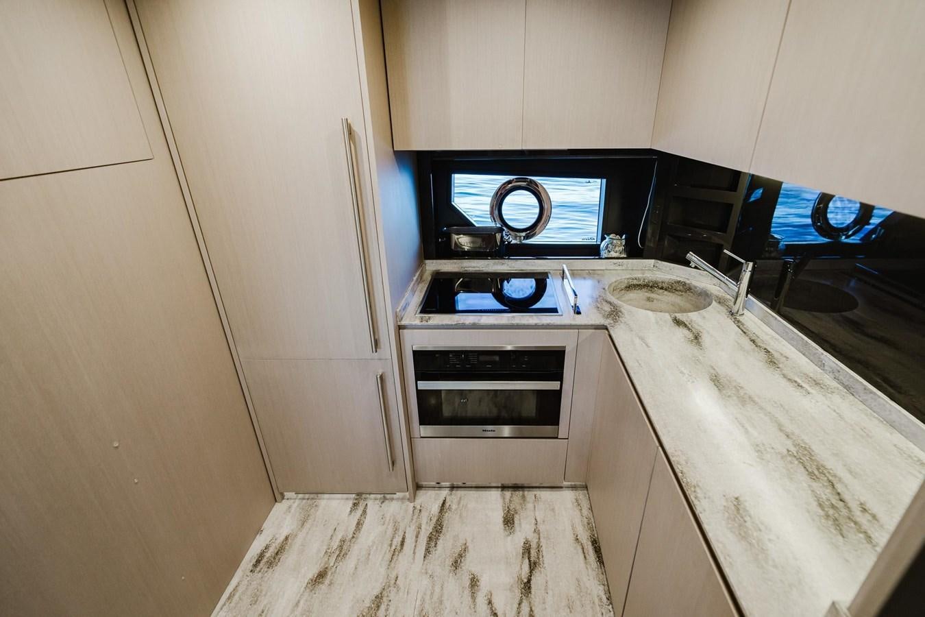 a kitchen with a stove and oven aboard 2021 RIVA 76' BAHAMAS Yacht for Sale