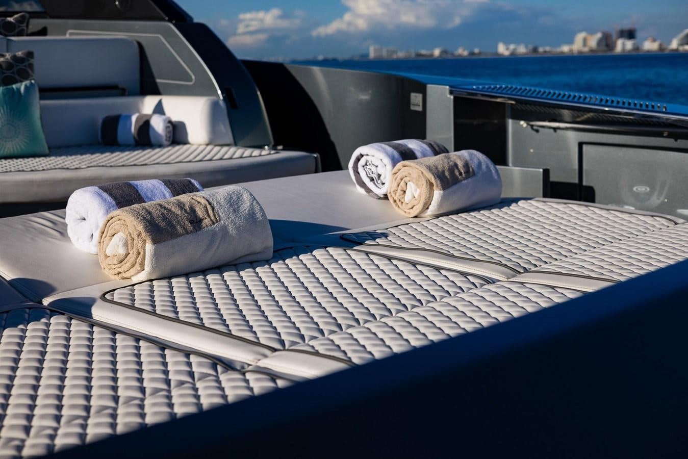 a couple of white bottles on a table in front of a window aboard 2021 RIVA 76' BAHAMAS Yacht for Sale