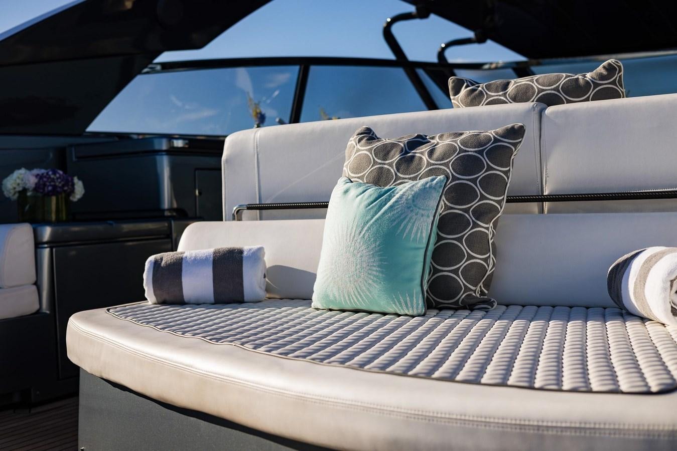 a couch with pillows aboard 2021 RIVA 76' BAHAMAS Yacht for Sale