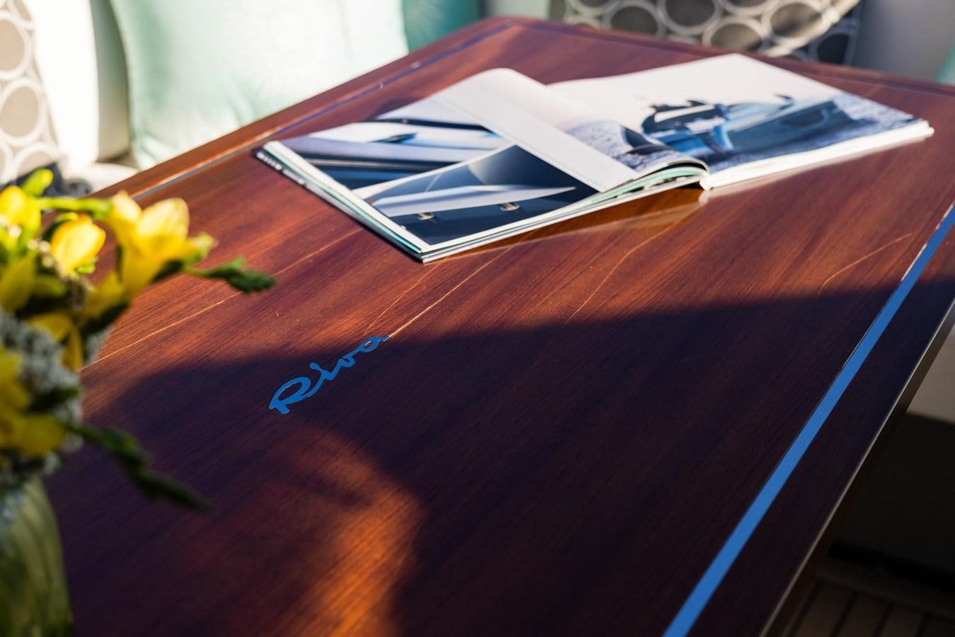a book on a table aboard 2021 RIVA 76' BAHAMAS Yacht for Sale