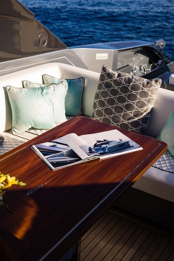 a boat with pillows and a table aboard 2021 RIVA 76' BAHAMAS Yacht for Sale