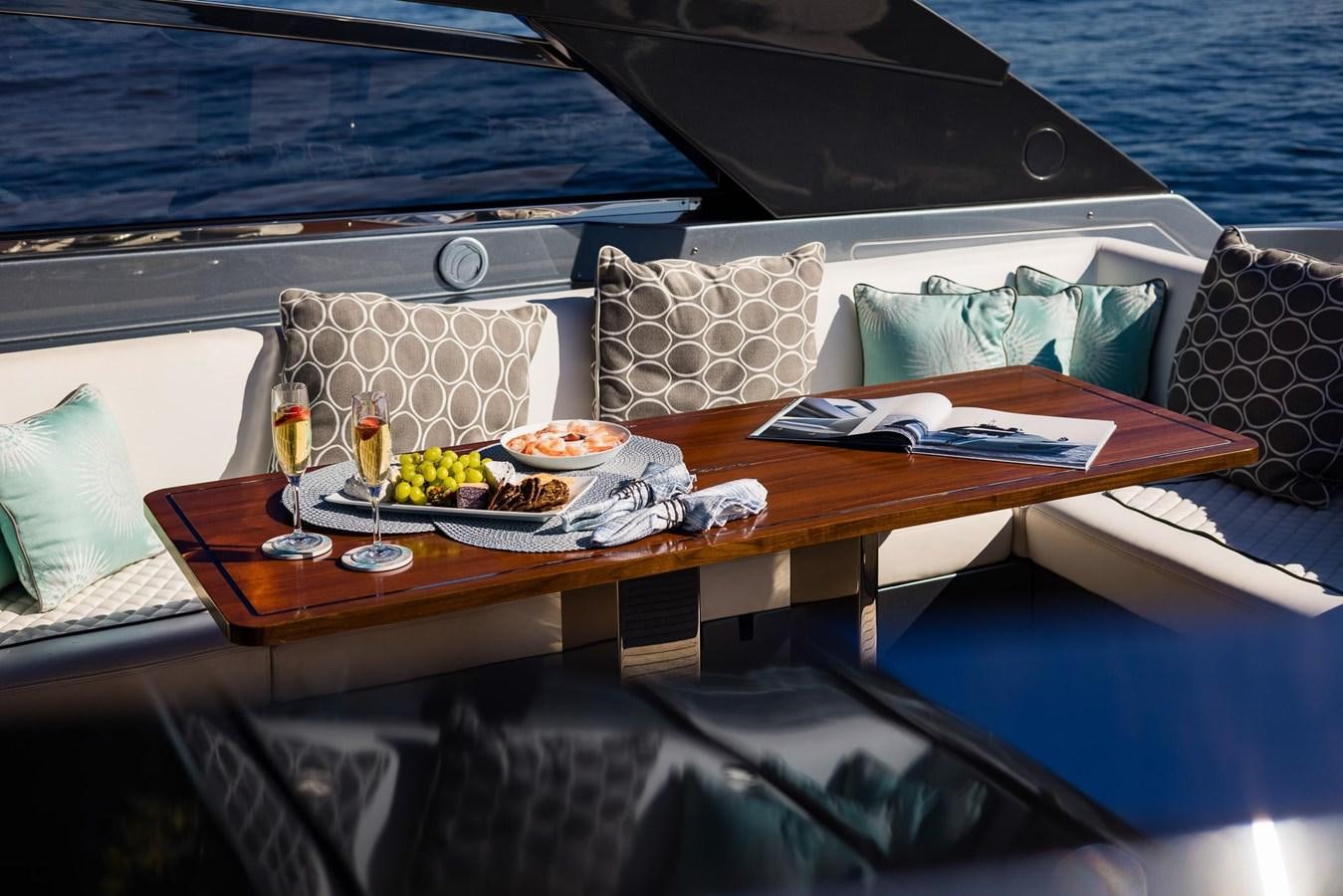 a boat with a tray of food and drinks on it aboard 2021 RIVA 76' BAHAMAS Yacht for Sale