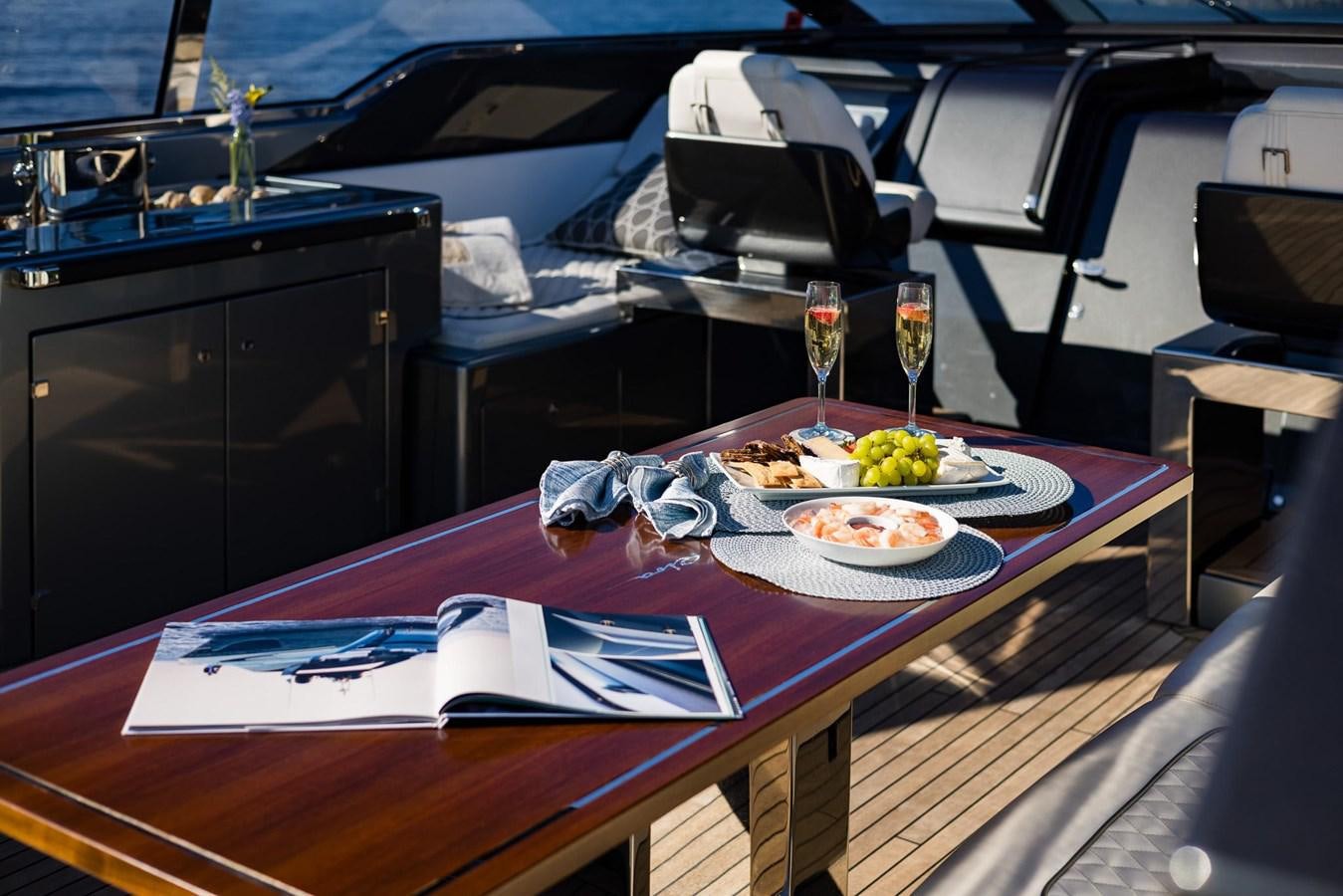 a table with food on it aboard 2021 RIVA 76' BAHAMAS Yacht for Sale