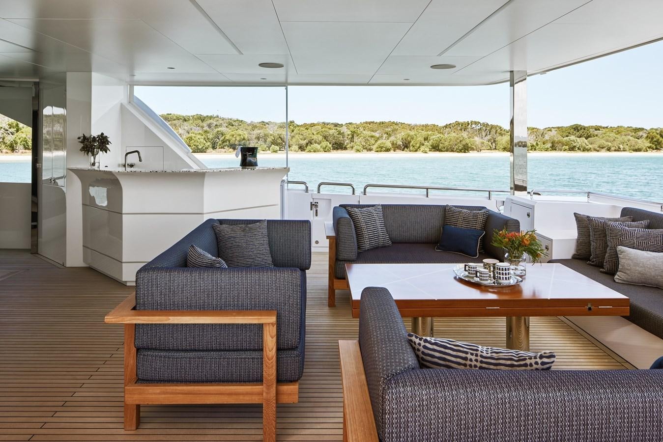 a living room with a couch and a table aboard ASKARI Yacht for Sale
