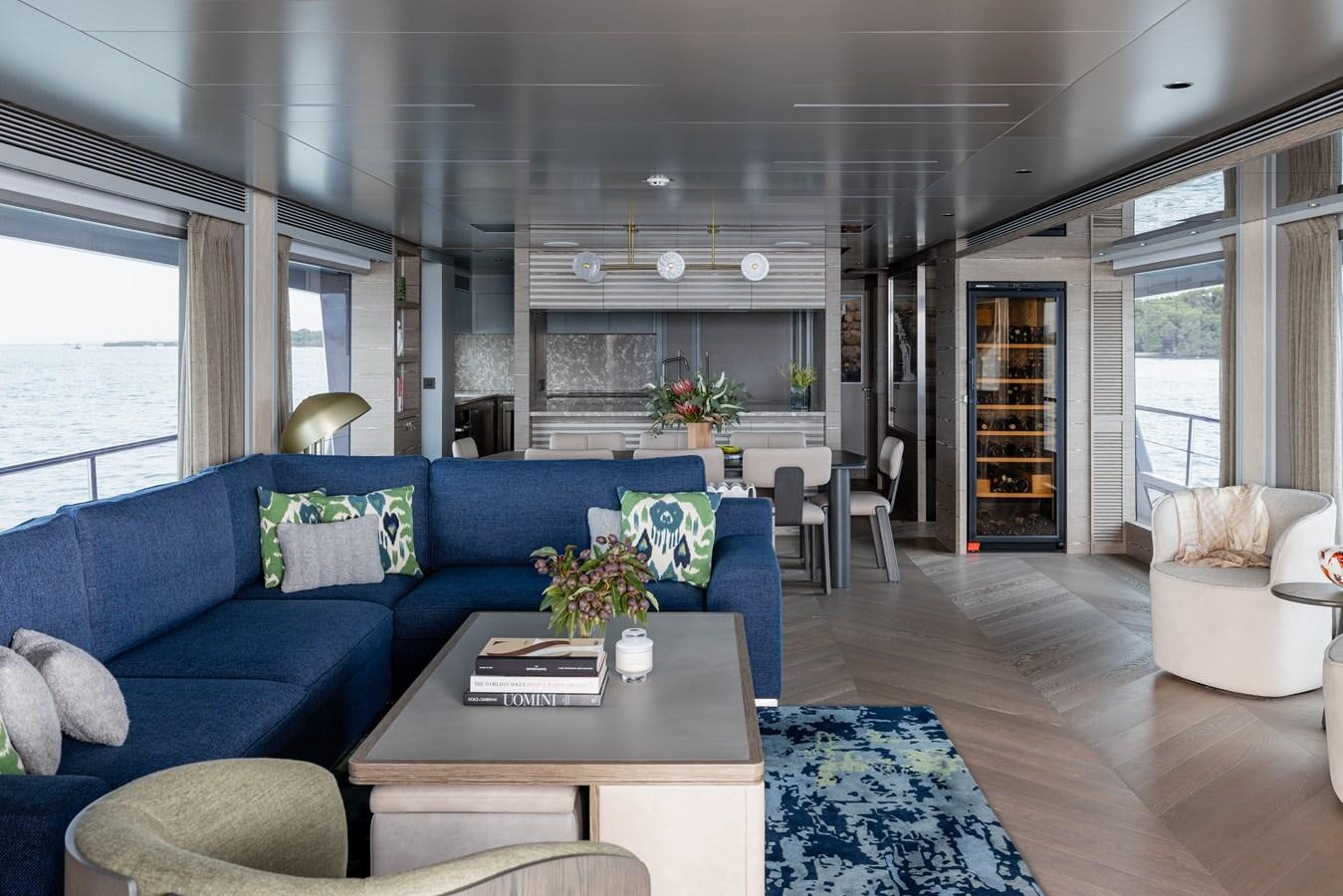 a living room with a blue couch aboard ASKARI Yacht for Sale