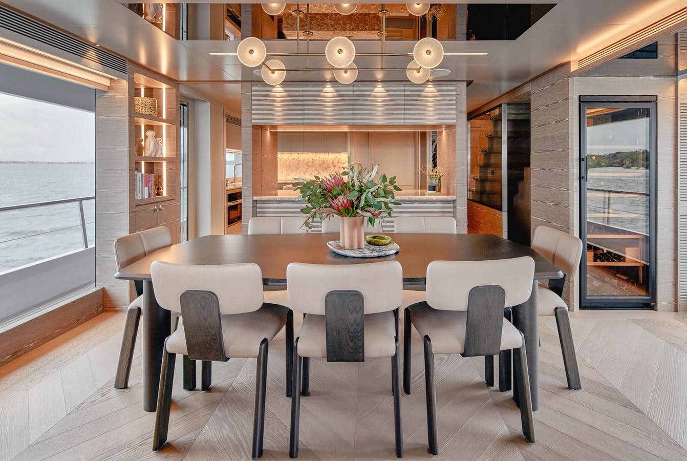 a room with a table and chairs aboard ASKARI Yacht for Sale