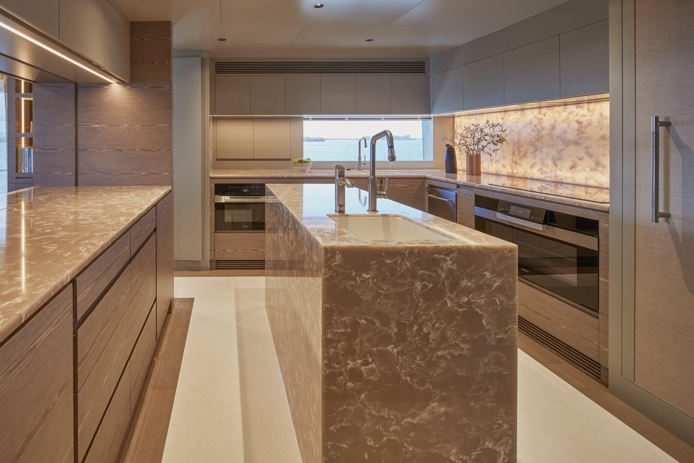 a kitchen with a marble counter top aboard ASKARI Yacht for Sale