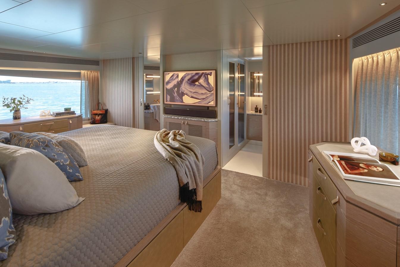 a bedroom with a bed and a television aboard ASKARI Yacht for Sale