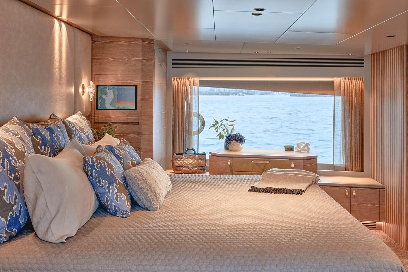 a bed with pillows and a table aboard ASKARI Yacht for Sale