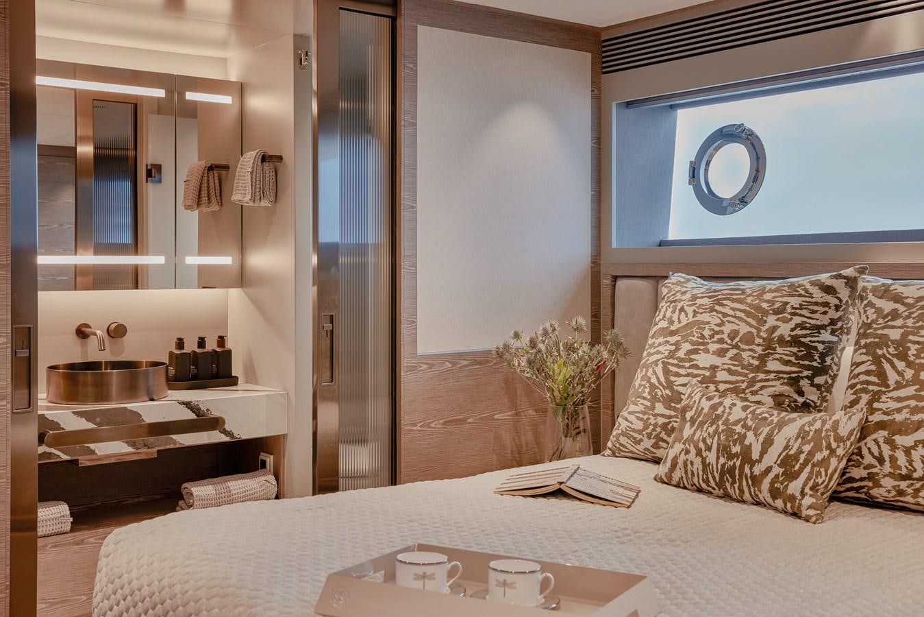 a bedroom with a bed and a desk aboard ASKARI Yacht for Sale