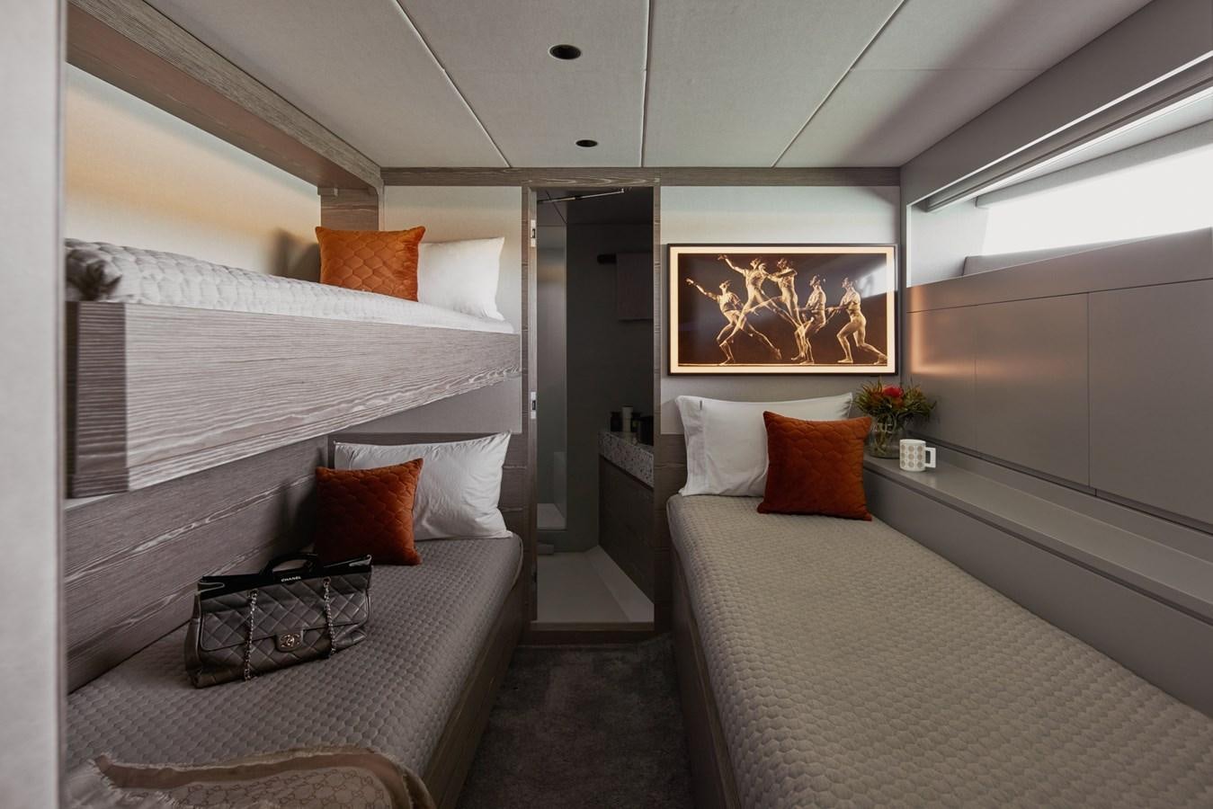 a room with a bed and a couch aboard ASKARI Yacht for Sale