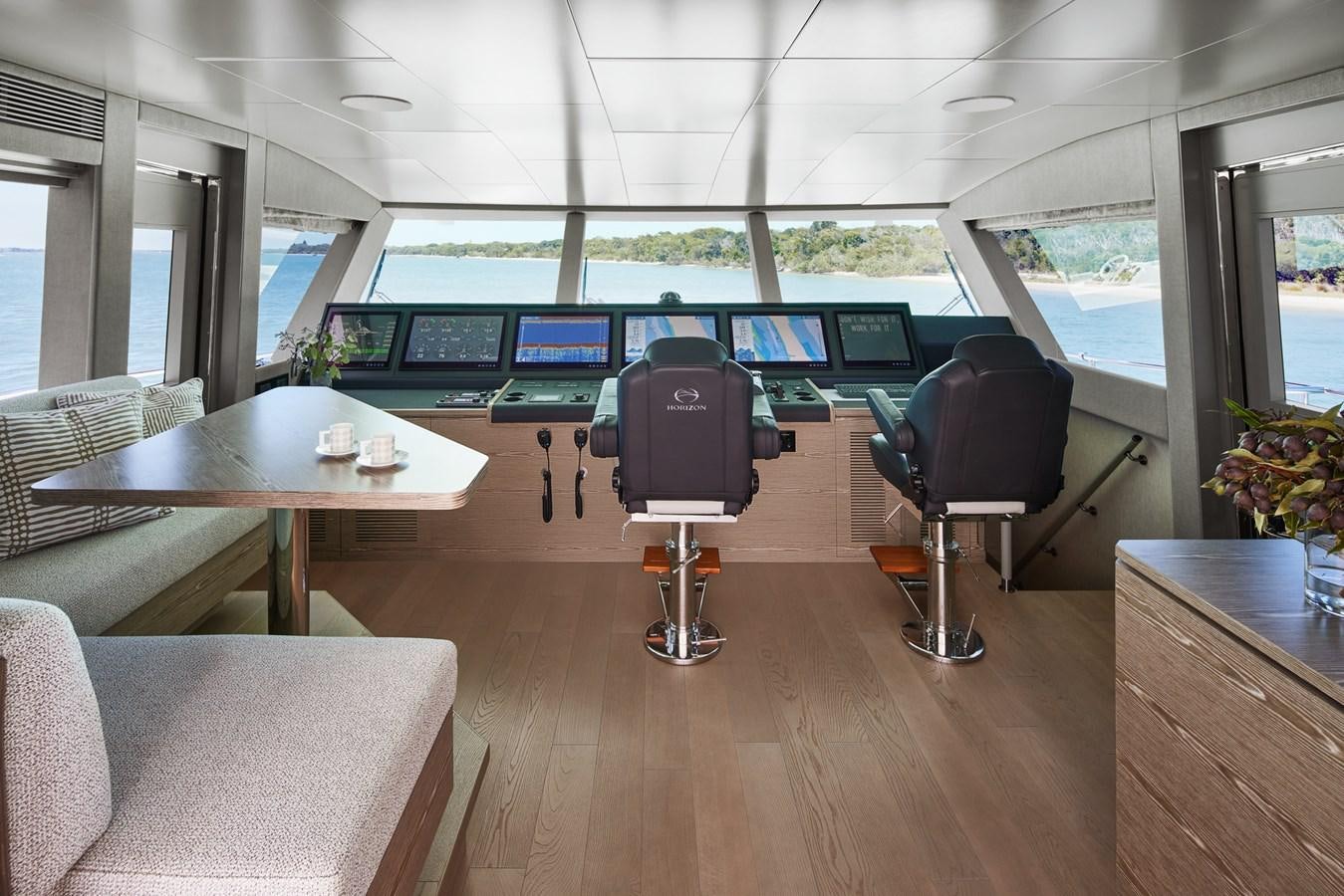 a room with a table and chairs aboard ASKARI Yacht for Sale