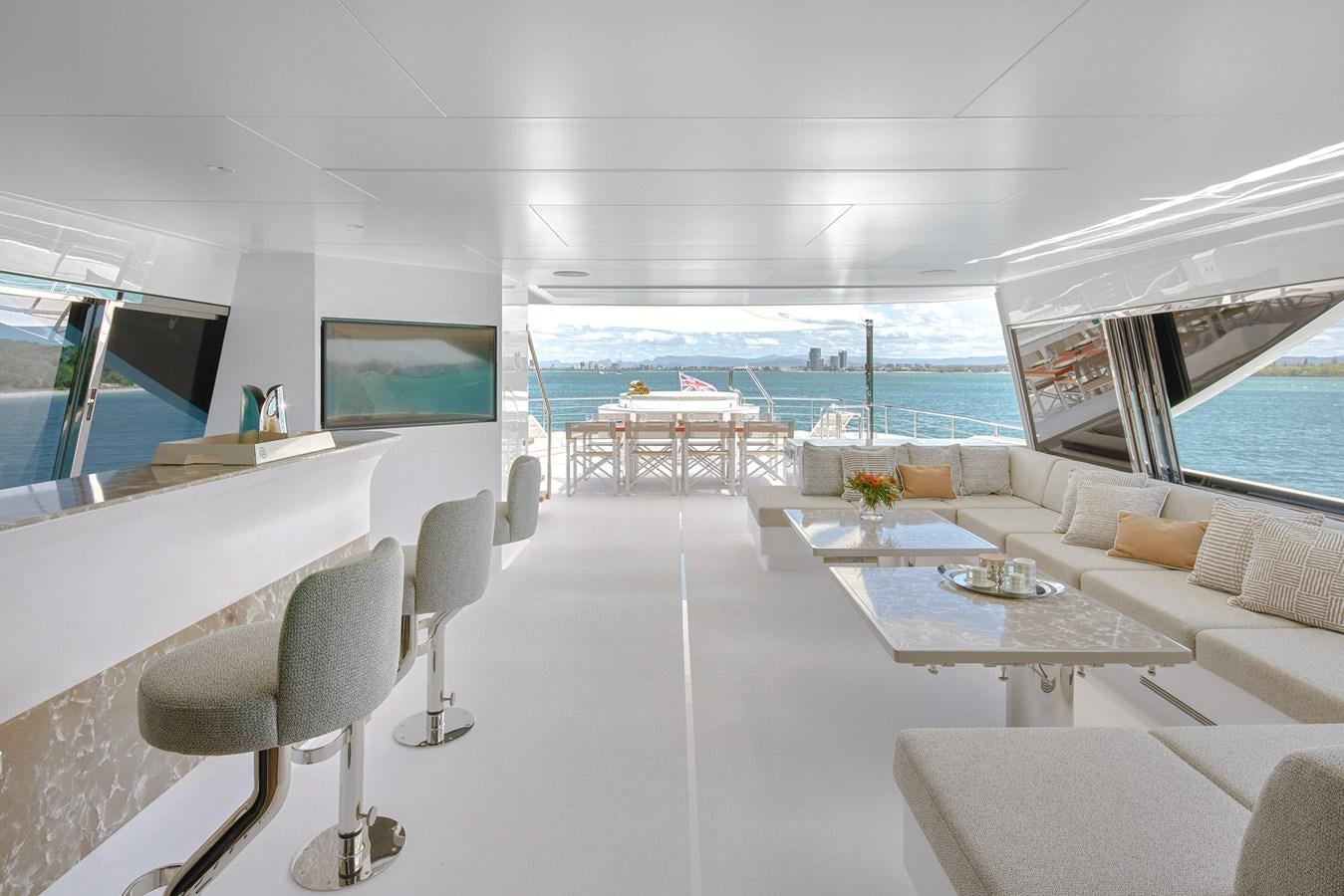 a room with a table chairs and a tv aboard ASKARI Yacht for Sale