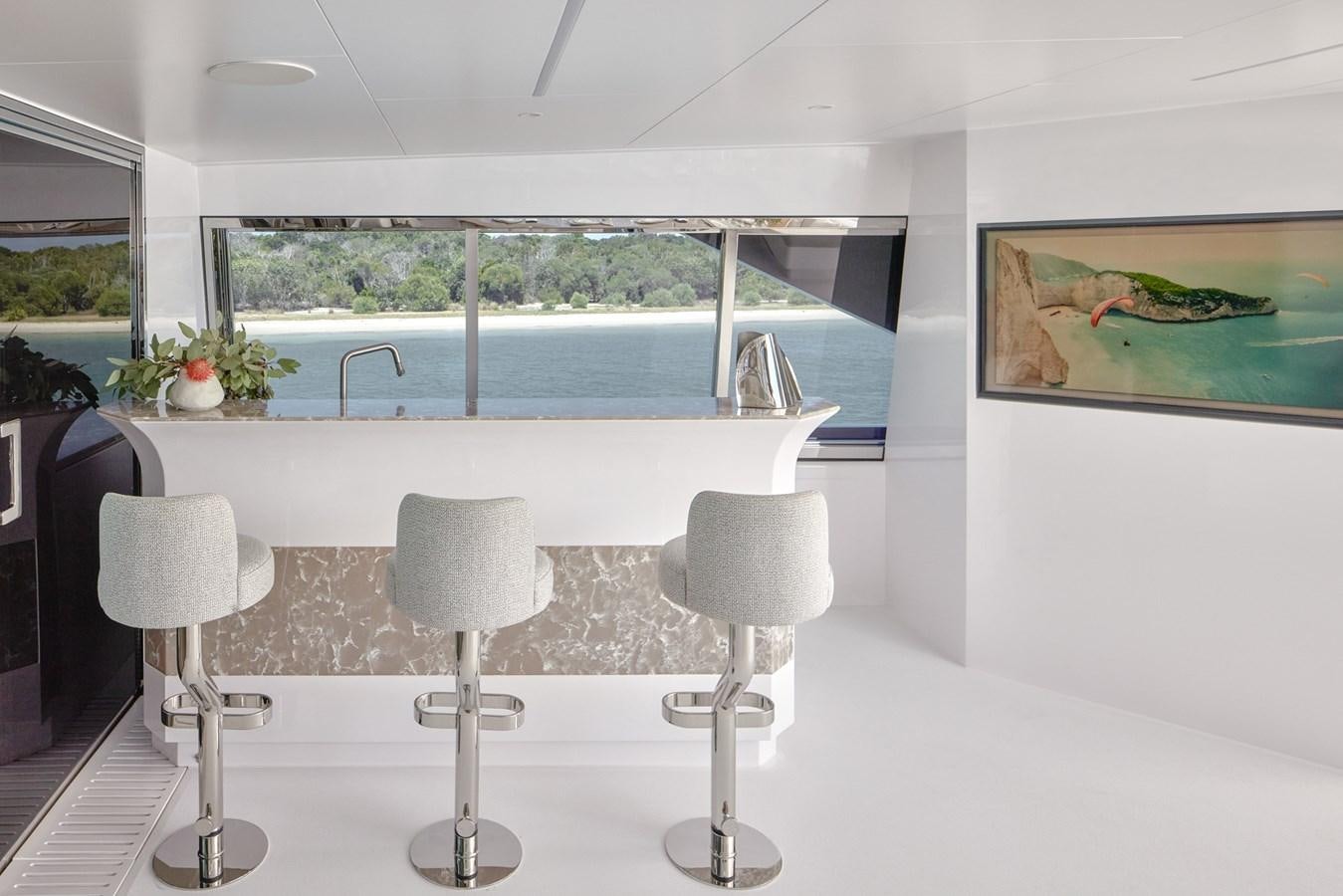 a white kitchen with a large window aboard ASKARI Yacht for Sale