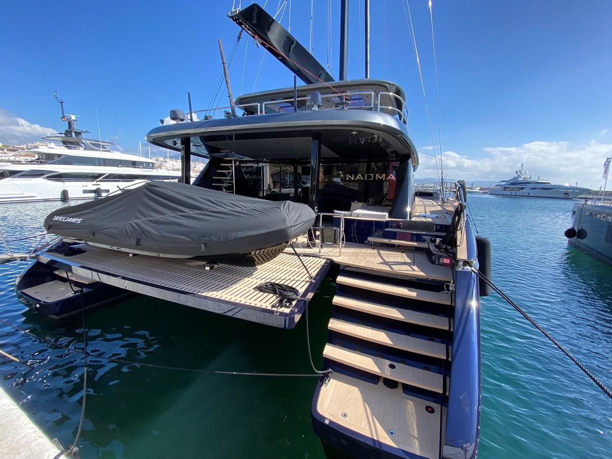 a boat docked at a pier aboard NAOMA Yacht for Sale