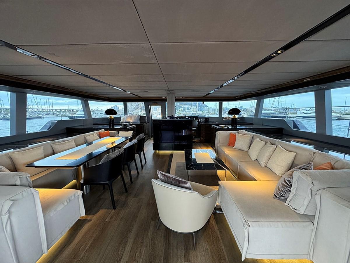 inside of a vehicle with a table and chairs and a couch aboard NAOMA Yacht for Sale