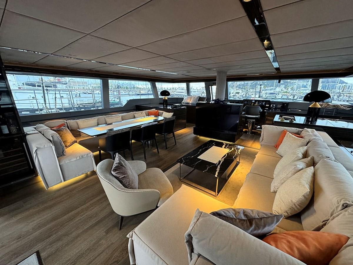 a room with couches and a table and chairs aboard NAOMA Yacht for Sale