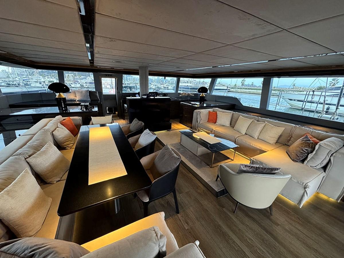 a room with a couch and a table and chairs aboard NAOMA Yacht for Sale