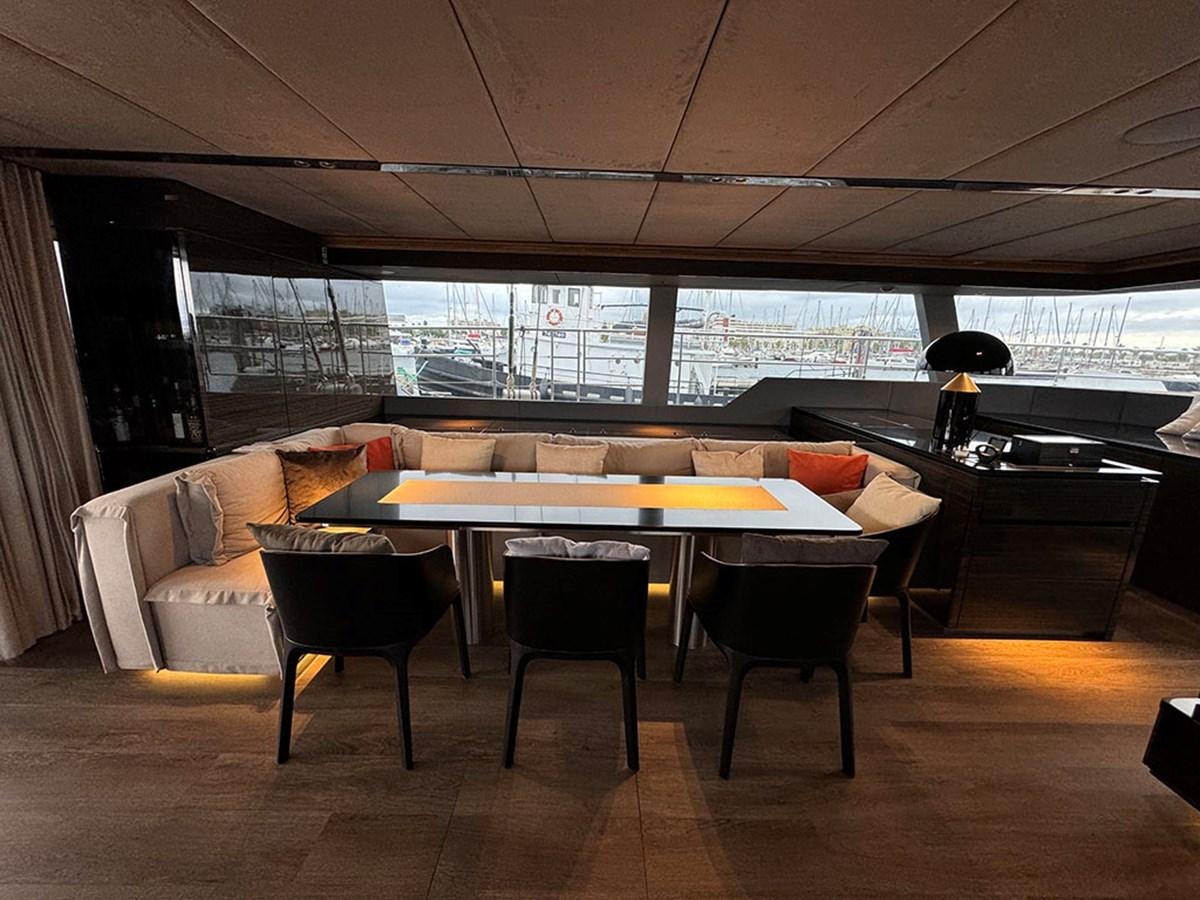 a room with a table and chairs aboard NAOMA Yacht for Sale