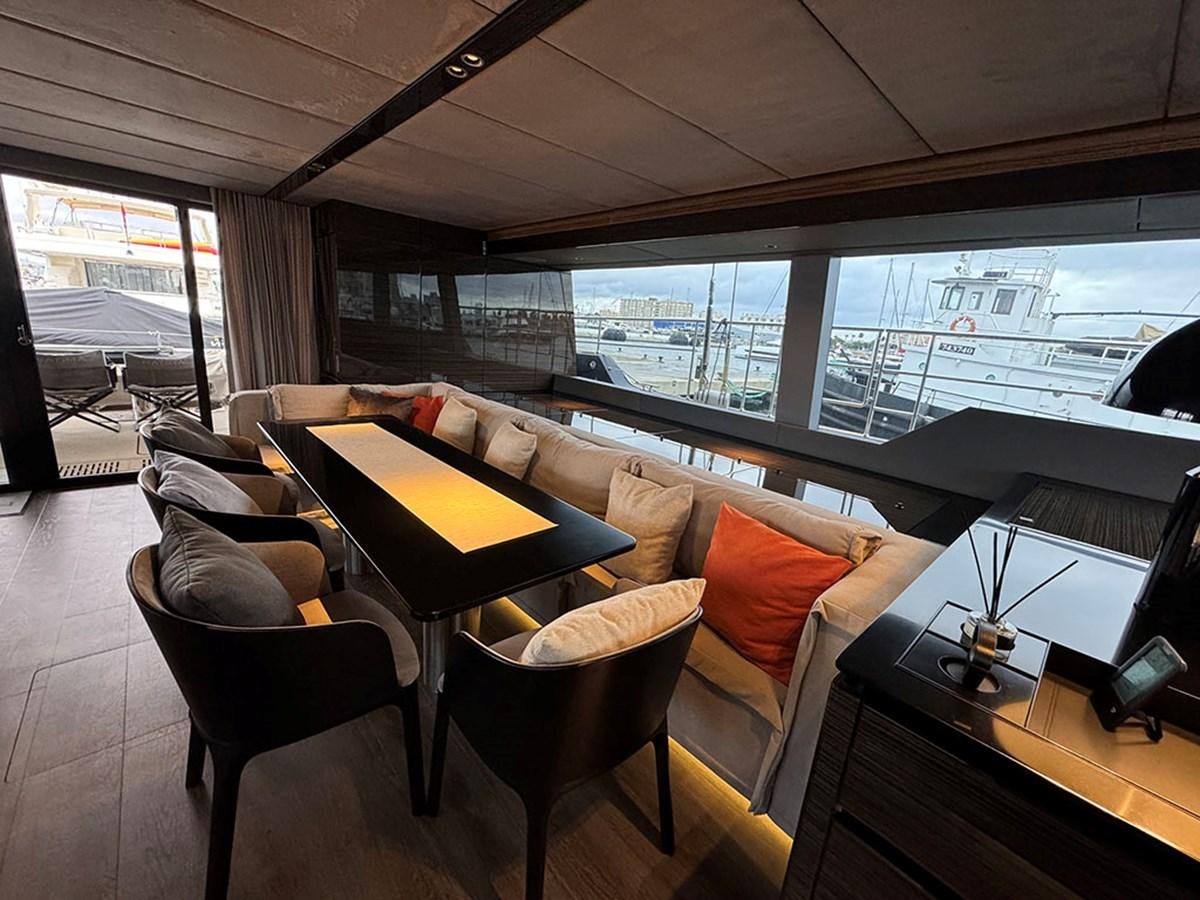 a living room with a couch and a table aboard NAOMA Yacht for Sale