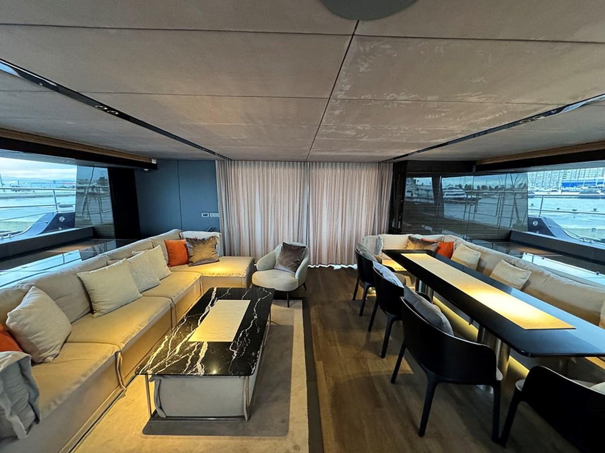 a room with a couch and a table and a window aboard NAOMA Yacht for Sale